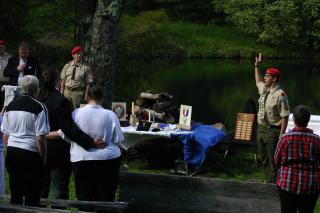 An Eagle Scout, hand raised in salute, reciting the Eagle Scout Oath