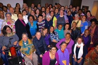 Unitarian Universalist religious professionals of many races and ethnicities pose for a group shot.