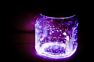A jar filled with glowing, purple sparks.
