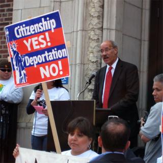 Sinkford speaking at an immigration rally; a sign in the foreground reads: 'Citizenship YES! Deportation NO!'