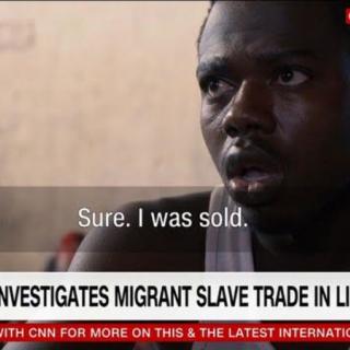 A subtitle shows an African migrant saying "Sure. I was sold." over a chyron reading "CNN Team Investigates Migrant Slave Trade in Libya"