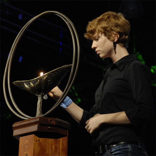 A youth lights a chalice. Photo by Nancy Pierce.