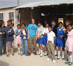 Members of First UU Church of Rochester, NY, pose with Mexican youth on the U.S.-Mexico border. Photo courtesy First UU Church of Rochester, NY.