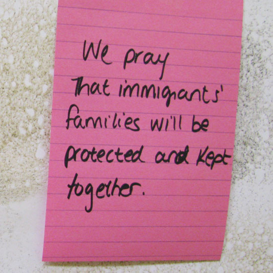 A note on a wall: 'We pray that immigrants' families will be protected and kept together.' Photo by Lisa Swanson/UUA.