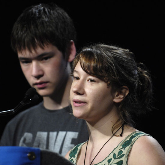Two youth speaking at a microphone. Photo by Nancy Pierce.