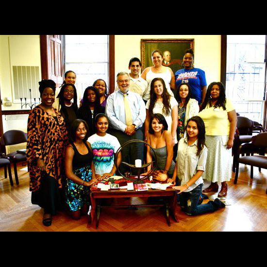 Youth and young adults of color pose with UUA President Peter Morales. Photo by UUA/Shelby Meyerhoff.