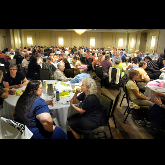 People sitting at a tables, talking. Nancy Pierce.