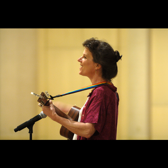 Woman playing a guitar. Nancy Pierce.