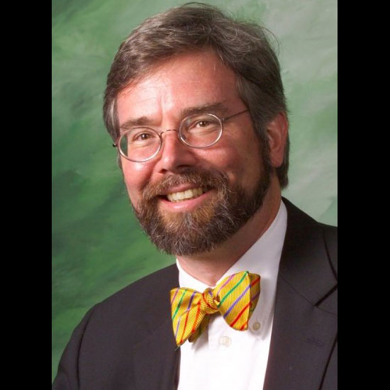 Eric Alan Isaacson, smiling in a formal headshot. Photo courtesy Eric Alan Isaacson.
