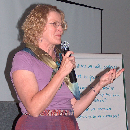 Veronica Lassen, speaking into a microphone. Photo by Bill Lewis.