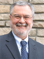 Peter Morales in a suit, smiling. Photo courtesy Peter Morales.
