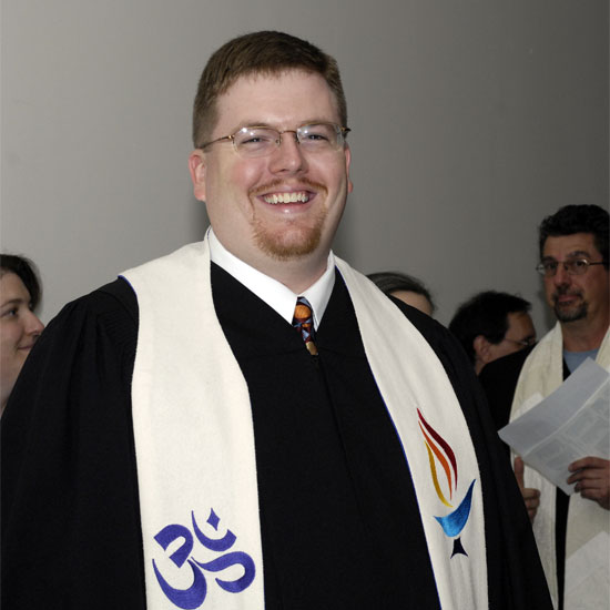 Jason Shelton, grinning in his ministerial garb. Photo by Nancy Pierce.