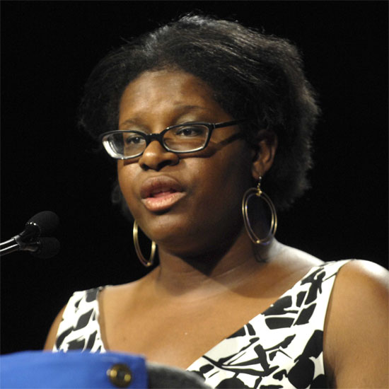 Eleandria Williams, speaking at a microphone. Photo by Nancy Pierce.