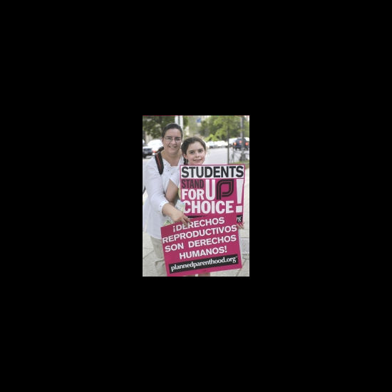 A woman and child hold a sign which reads: 'STUDENTS STAND FOR UP CHOICE'. UUA archives.