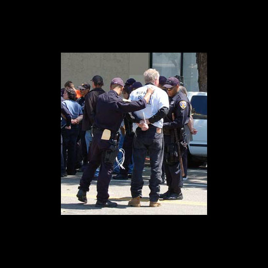 Rev. Greg Stewart being arrested. Photo by Robert Packenham.