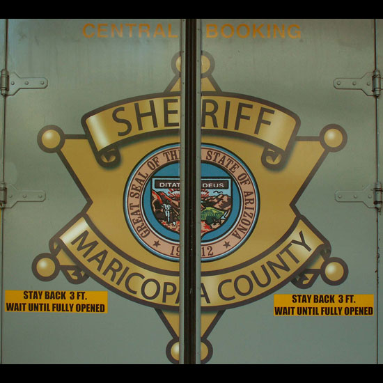 Doors showing the logo of Central Booking at the Maricopa County Sheriff's Office. Photo by Cobalt123/Flickr.