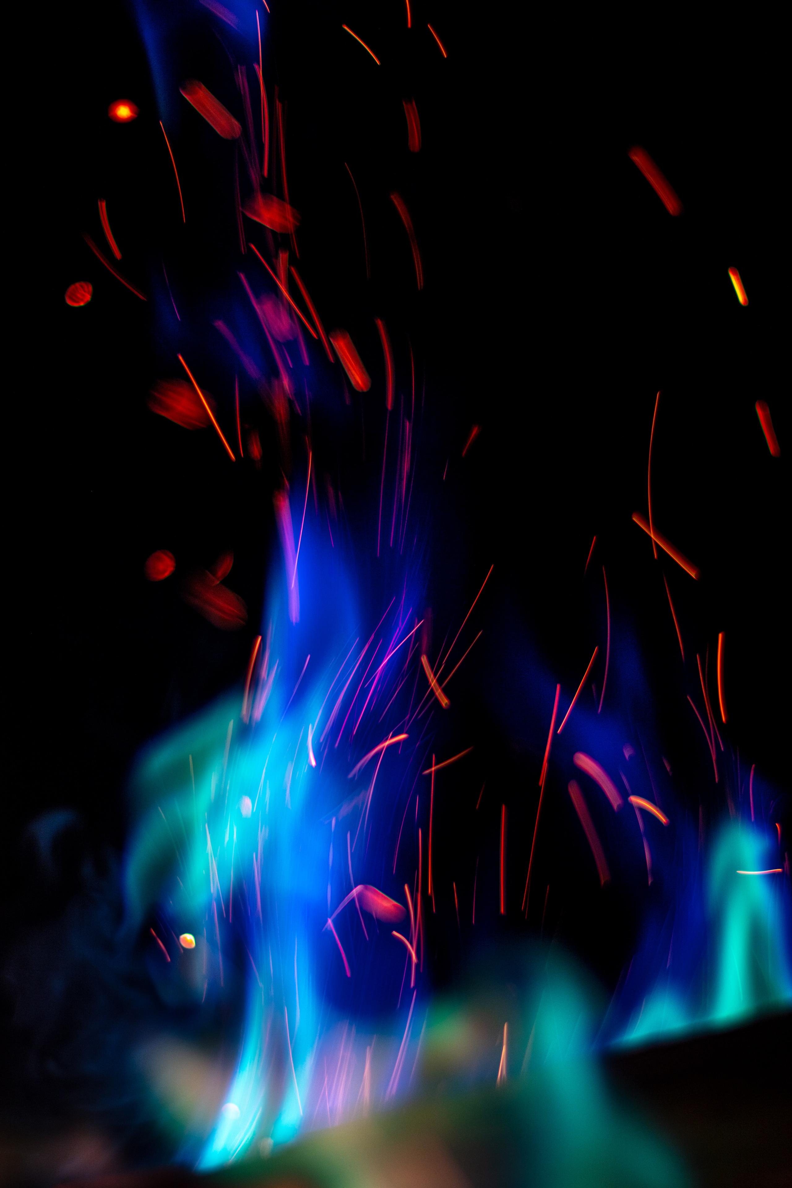A blue flame emitting red sparks
