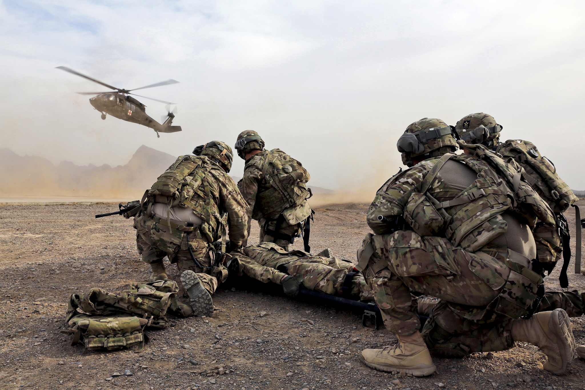 Security force team members for Provincial Reconstruction Team (PRT) Farah wait for a UH-60 Black Hawk medevac helicopter to land before moving a simulated casualty during medical evacuation training on FOB Farah, Jan. 9
