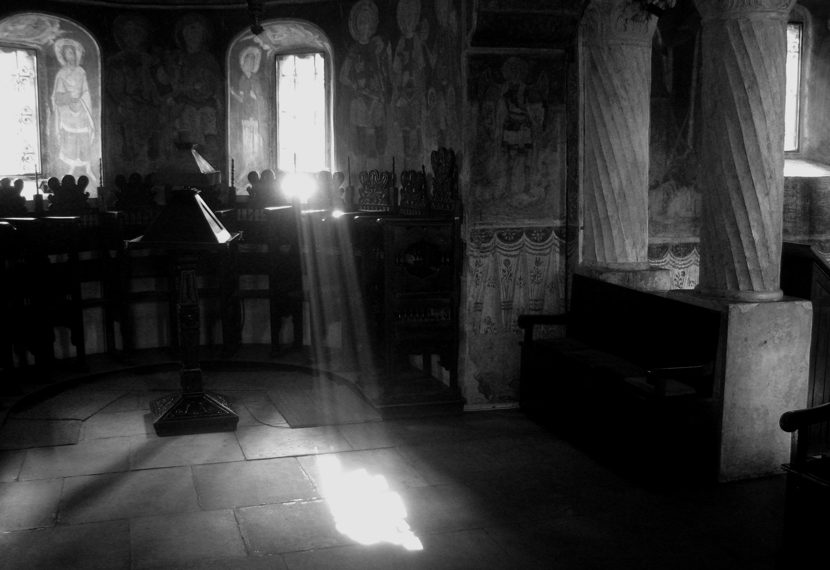 A black and white photo of a sunbeam cutting through the chancel of the Stavropoleos Monastery (Bucharest, Romania)