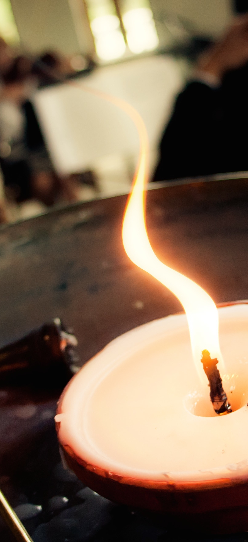 A flame rises from the flaming chalice, a symbol of Unitarian Universalist faith.