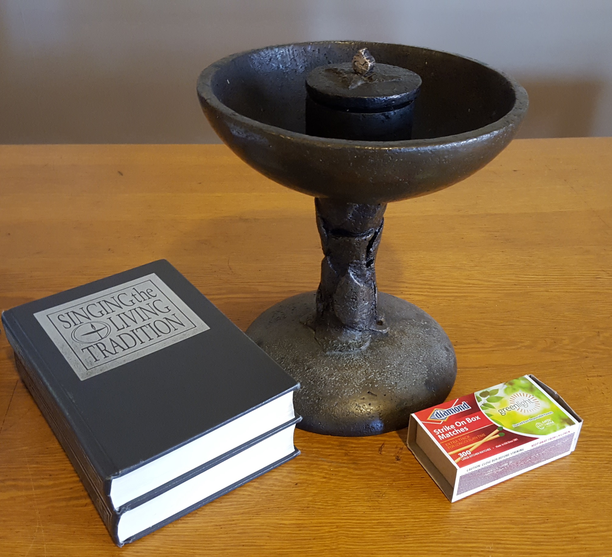 Chalice, hymnals and matches on a table