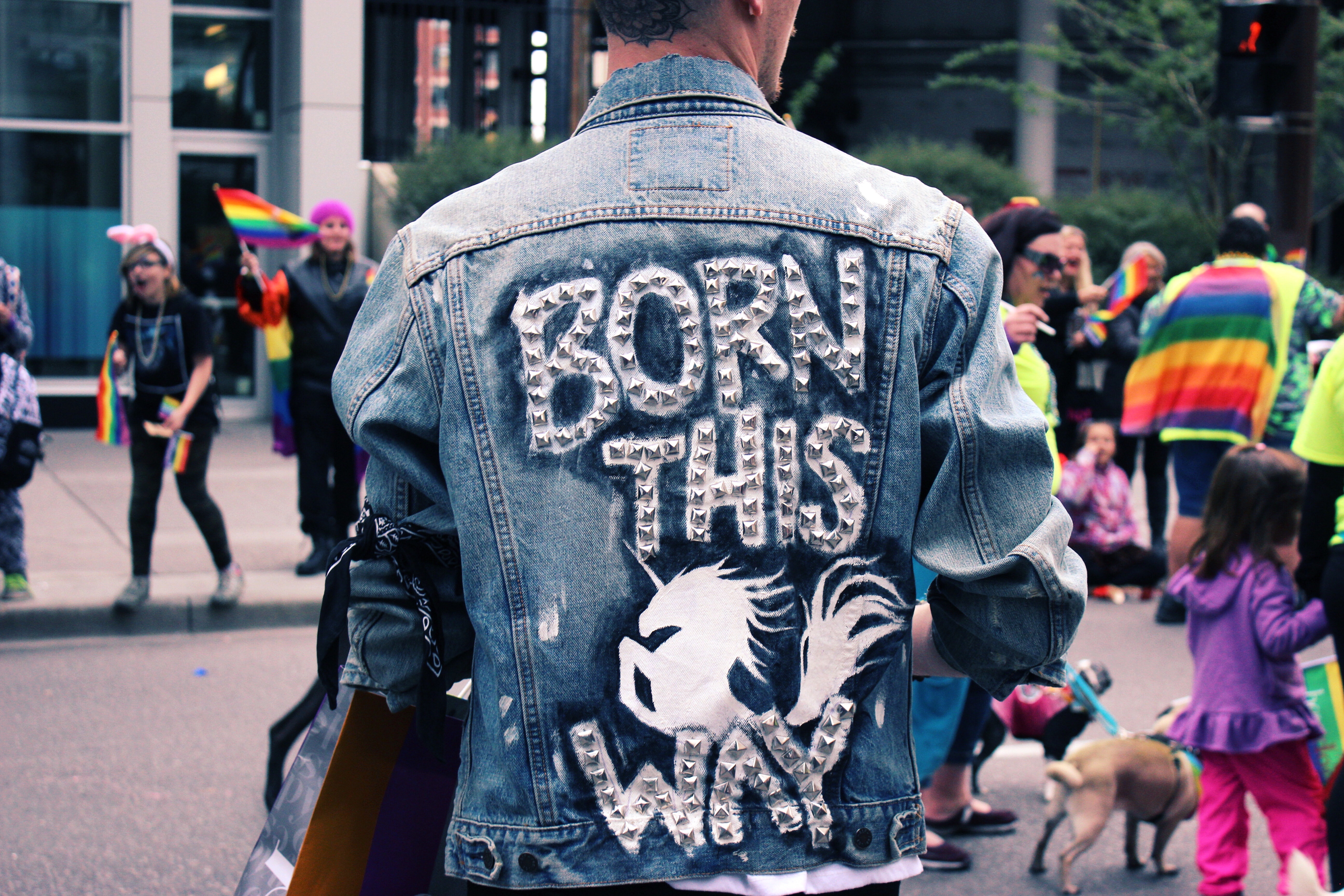 The back of a person's denim jacket says, 