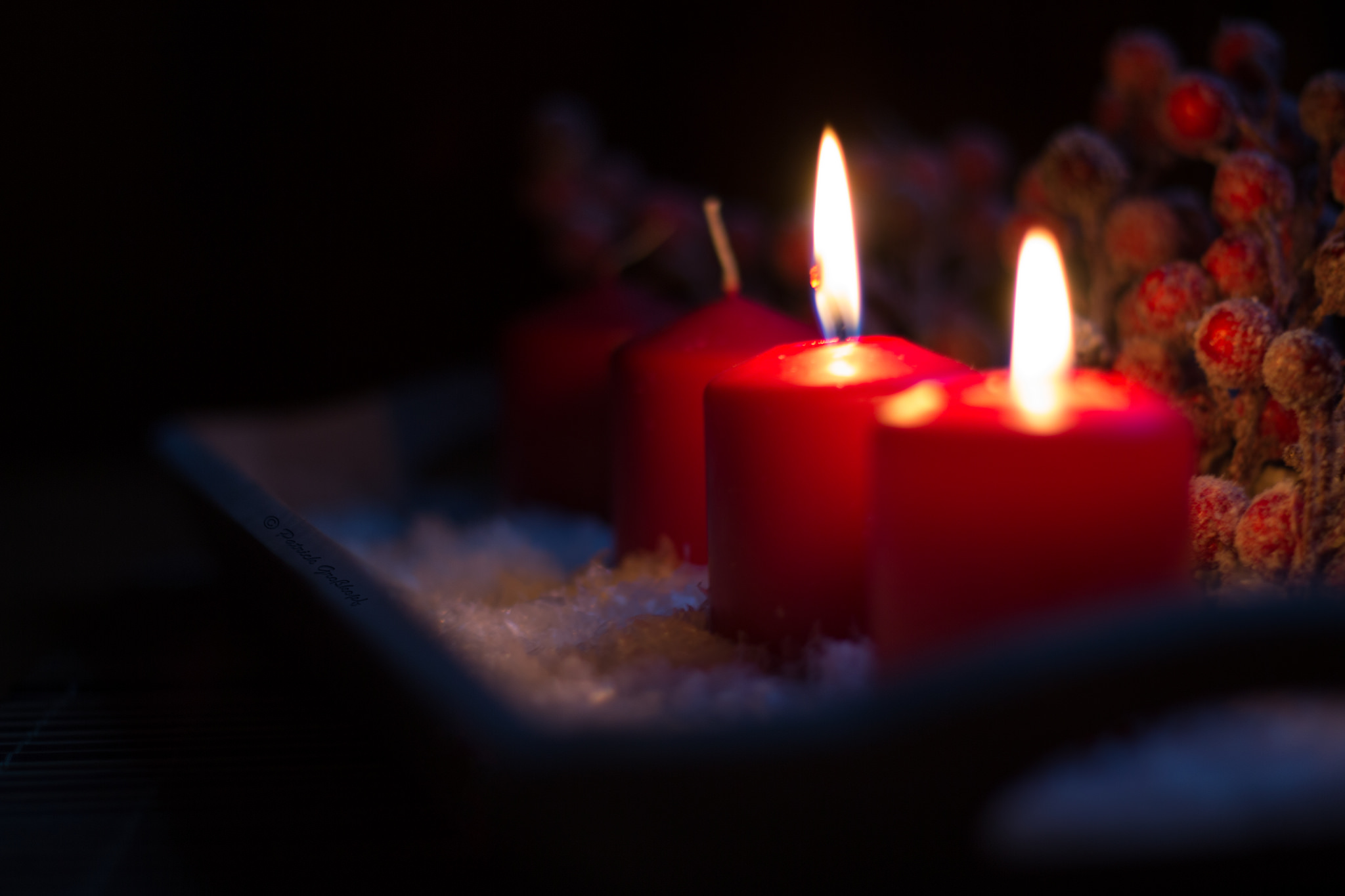 Two lit candles on an advent 