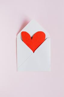 Envelope with red paper heart in it