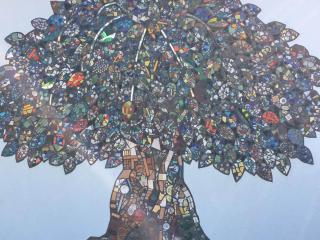 A mosaic--made with many pieces of broken glass--forming large tree.