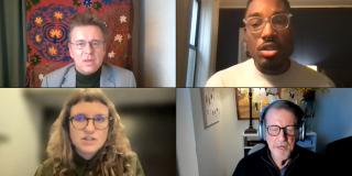 Screenshot grid of four videoconference windows: One is a white man wearing glasses and a grey suit; one is a black man wearing glasses, a septum piercing, and a white sweater; one is a white woman wearing glasses and an olive shirt; one is a white man wearing glasses and a black sweater