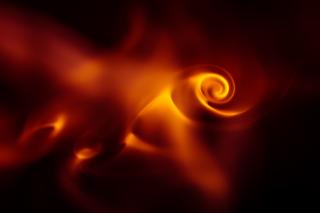 An abstract image of a bright spiral-shaped flame against a dark background.