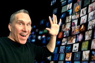 Image of Peter Bowden in front of digital screens.