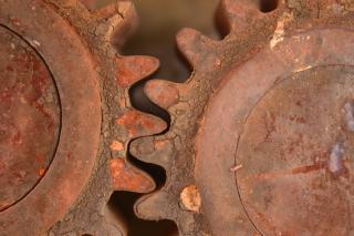 Two larged rusted gears with teeth engaged