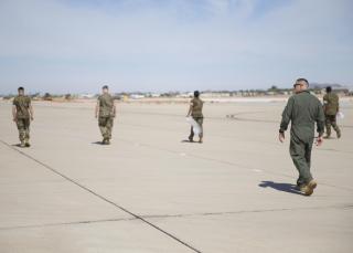 U.S. Marine Corps Capt. Richard Hetrick, an aviation safety officer with Headquarters and Headquarters Squadron, oversees Marines conducting Foreign Object Debris (FOD) walk at Marine Corps Air Station Yuma, Ariz., June 7, 2021.