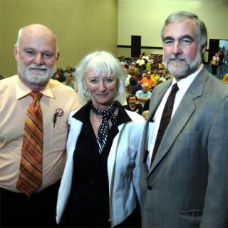 Charlie Clements, Sharon D. Welch, and William F. Schulz standing in front of the attendees for their workshop.