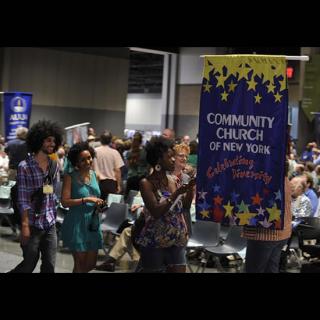 Members of the Community Church of New York walk in the banner parade.