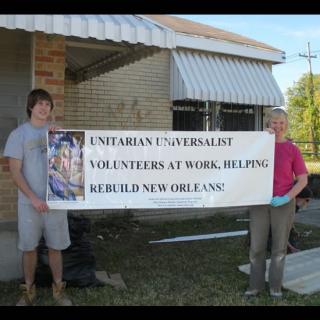 UU volunteers hold sign for rebuilding New Orleans.