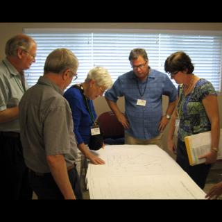 Congregational leaders examine the plans for a new building.