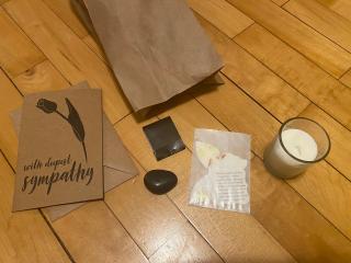 Paper bag, candle, matches, stone, seed paper and a sympathy card