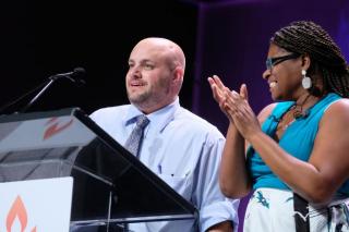 Mr. Barb Greve (left) and Elandria Williams (right), Co-Moderators of the UUA, standing in front of podium at opening of General Assembly 2019
