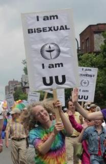 A proud UU marches in a 2012 Pride parade holding a "I am bisexual, I am UU" sign.