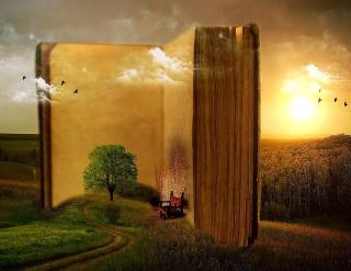 Large open book embedded in a pastoral scene with tree, chair and sunset