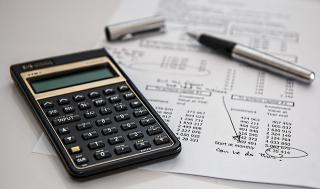 a calculator, pen and spreadsheet