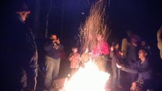 Many generations gather around the campfire to roast marshmallows 