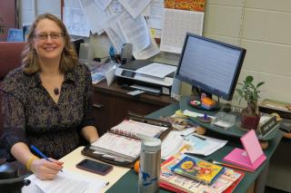 Diane Melvin, Credentialed Religious Educator, at desk