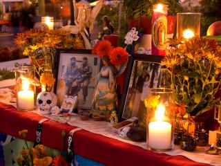 An altar filled with candles, photos, and flowers