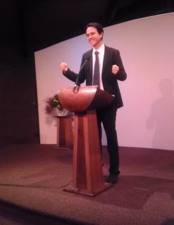 Photo of Derek Mitchell preaching at a podium