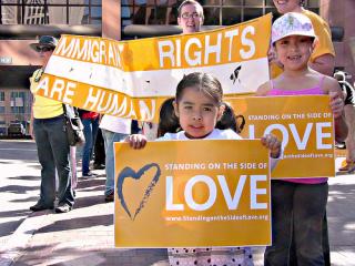 Children hold Standing on the Side of Love signs as they participate in Immigrant Rights Protest in San Diego, CA.