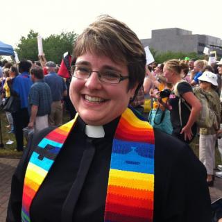 Rev. Lisa Bovee-Kemper in clergy collar and stole (smiling big)