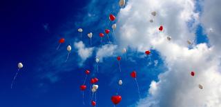 Heart shaped balloons floating in the sky